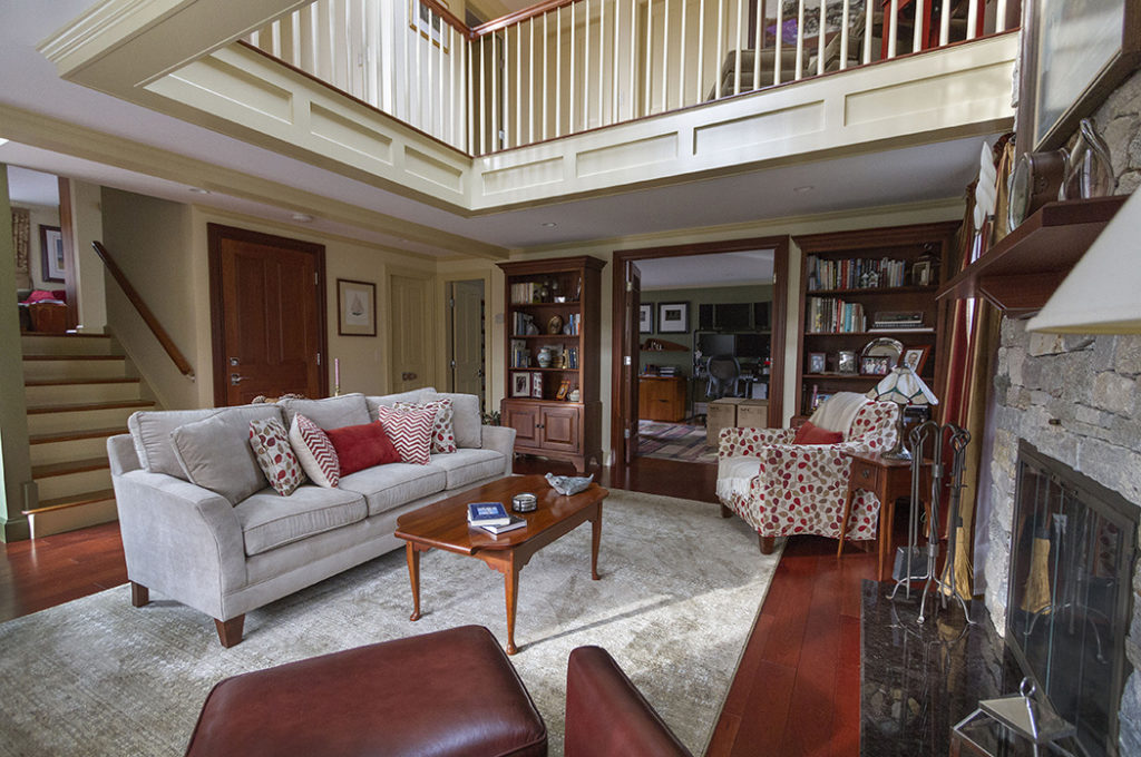 Living room with the second story balcony railing built by Haggett Company